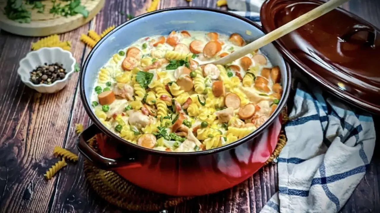 Herzhafte Nudelpfanne mit Würstchen, Erbsen und Hähnchen in cremiger Soße – tolle Suppen Ideen für kalte Tage.